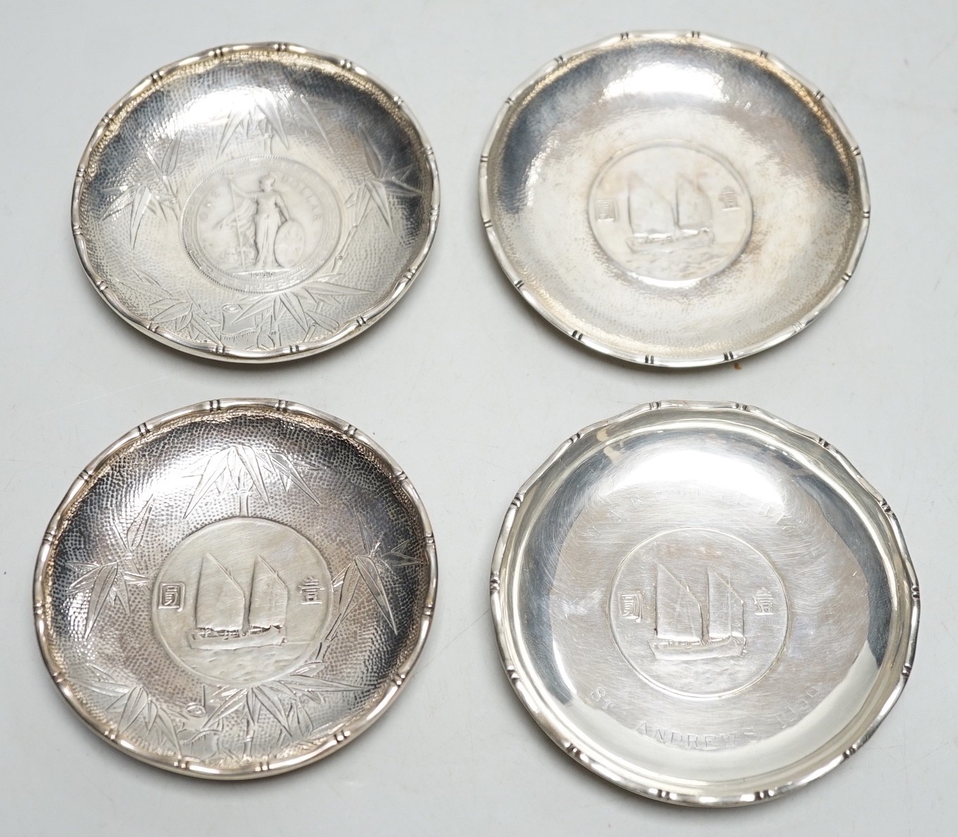 Three Hong Kong white metal mounted Republic of China coin dishes and a similar One Dollar 1930 dish, largest diameter 9cm.